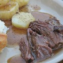 A close up photo of slow cooker roast with brandy sauce. 