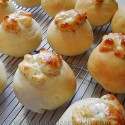 A close up photo of gooey garlic cheese rolls resting on a cooling rack.