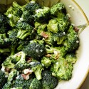 A close up photo of a bowl of broccoli salad.