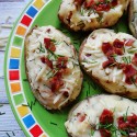 An overhead photo of a plate of cheesy bacon and chive twice baked potatoes.