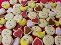 Spread out colorful cookies on a baking sheet.