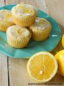 Orange cupcakes stacked up on a small white plate.